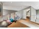 Open loft area with carpet flooring, exercise equipment, and doorway leading to the bedroom at 1642 S Trenton St, Denver, CO 80231