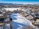 Aerial view of a community with snow covered homes and open space at 7700 W Glasgow Pl # 19C, Littleton, CO 80128