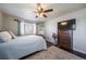 Spacious bedroom with wood floors, ceiling fan, and dresser at 7700 W Glasgow Pl # 19C, Littleton, CO 80128