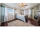 Cozy bedroom with wood floors, a ceiling fan, and large windows at 7700 W Glasgow Pl # 19C, Littleton, CO 80128