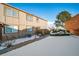 Exterior view of a townhouse with a snow-covered yard and walkway at 7700 W Glasgow Pl # 19C, Littleton, CO 80128