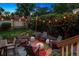 Backyard featuring a patio with comfortable seating, a colorful rug, and lush landscaping under string lights at 1007 N Ogden St, Denver, CO 80218