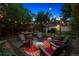 Backyard patio area with string lights, comfortable seating, and lush greenery at 1007 N Ogden St, Denver, CO 80218