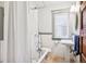 Classic bathroom with vintage-style fixtures, a bathtub, and a window at 1007 N Ogden St, Denver, CO 80218