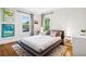 Cozy bedroom with hardwood floors, decorative windows, stylish linens, and modern décor at 1007 N Ogden St, Denver, CO 80218