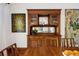 An antique wooden hutch adds character to this dining room with a large painting on the wall at 1007 N Ogden St, Denver, CO 80218