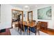 Elegant dining room showcasing a wood table, stylish chairs, pendant lighting, and views to other rooms at 1007 N Ogden St, Denver, CO 80218