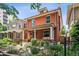 Charming two-story brick home with a landscaped front yard and inviting porch swing at 1007 N Ogden St, Denver, CO 80218