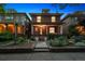 Beautiful brick home with a charming porch, mature trees, and a landscaped front yard at 1007 N Ogden St, Denver, CO 80218