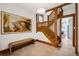 Grand foyer with wood staircase, large artwork, and tiled flooring at 1007 N Ogden St, Denver, CO 80218