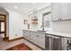 Bright kitchen featuring modern appliances, white cabinets, and white backsplash, with a decorative tile floor at 1007 N Ogden St, Denver, CO 80218