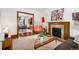 Inviting living room with a decorative fireplace and a view into the dining room and wood floors at 1007 N Ogden St, Denver, CO 80218