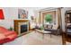 Cozy living room featuring a decorative fireplace, hardwood floors, and ample natural light at 1007 N Ogden St, Denver, CO 80218
