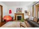Bright living room with decorative fireplace, hardwood floors, and unique artwork at 1007 N Ogden St, Denver, CO 80218