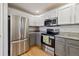 Kitchen featuring stainless steel appliances, granite countertops, and modern cabinets at 5350 S Jay Cir # 4A, Littleton, CO 80123