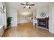 Living room with hardwood floors, fireplace, ceiling fan, and neutral color palette at 5350 S Jay Cir # 4A, Littleton, CO 80123