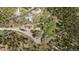 Aerial shot of a property showcasing the home, outbuildings, trees, and landscape at 8600 S Warhawk Rd, Conifer, CO 80433