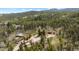 Expansive aerial view of the home nestled among dense trees on the property at 8600 S Warhawk Rd, Conifer, CO 80433