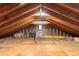 Unfinished attic showing rafters, insulation and storage space at 8600 S Warhawk Rd, Conifer, CO 80433
