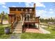 Beautiful wooden home with a large deck and stair access to the backyard at 8600 S Warhawk Rd, Conifer, CO 80433