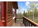 Charming balcony showcases wood railings and beautiful views of the lush landscape at 8600 S Warhawk Rd, Conifer, CO 80433