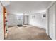 Bright basement featuring neutral carpet, white walls, and walk out access to the yard at 8600 S Warhawk Rd, Conifer, CO 80433