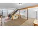 Expansive basement with exposed ceiling beams, stairs, and ample potential for customization at 8600 S Warhawk Rd, Conifer, CO 80433
