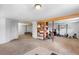 Spacious basement with neutral carpet, wood beams, built-in shelving, and exercise equipment at 8600 S Warhawk Rd, Conifer, CO 80433