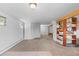 Expansive basement space with neutral carpet, white walls, and multiple entry points at 8600 S Warhawk Rd, Conifer, CO 80433