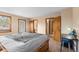 Cozy bedroom features a door to the outside, carpet, and adjacent bathroom at 8600 S Warhawk Rd, Conifer, CO 80433