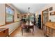 Bright dining room with wood floors, large windows, and elegant furnishings at 8600 S Warhawk Rd, Conifer, CO 80433