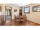 Cozy dining room featuring a wooden table, chairs, and natural light from the windows at 8600 S Warhawk Rd, Conifer, CO 80433