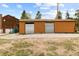 Large, detached two-door garage with metal doors and ample parking space, next to home at 8600 S Warhawk Rd, Conifer, CO 80433