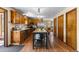 Spacious kitchen featuring wood cabinets, an island with seating, and stainless steel appliances at 8600 S Warhawk Rd, Conifer, CO 80433