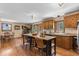 Open kitchen layout with a stone fireplace and lots of light at 8600 S Warhawk Rd, Conifer, CO 80433