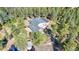 Stunning home with a dark roof, a large deck, and a paved driveway surrounded by mature trees at 11348 Ranch Elsie Rd, Golden, CO 80403