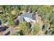 Expansive home featuring a large deck and surrounded by lush, mature trees at 11348 Ranch Elsie Rd, Golden, CO 80403