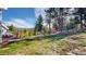 Scenic backyard featuring lush greenery, a small shed, and a pathway leading towards the property at 11348 Ranch Elsie Rd, Golden, CO 80403