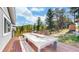 Spacious deck featuring mountain views, outdoor furniture, grill, and access to the backyard at 11348 Ranch Elsie Rd, Golden, CO 80403
