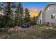 Backyard at dusk featuring mountain views and a fire pit gathering area at 11348 Ranch Elsie Rd, Golden, CO 80403