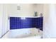 Bathroom featuring a jetted tub with tiled surround and modern fixtures at 11348 Ranch Elsie Rd, Golden, CO 80403