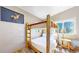 Charming bedroom with rustic log bunk bed, wood floors, and a bright window at 11348 Ranch Elsie Rd, Golden, CO 80403
