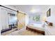 Bedroom with barn door to bathroom and large window with wooded views at 11348 Ranch Elsie Rd, Golden, CO 80403