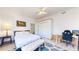 Bright bedroom featuring a queen bed, bench seat and office desk space at 11348 Ranch Elsie Rd, Golden, CO 80403