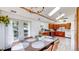 Bright dining room featuring ample natural light, a modern chandelier, and access to the backyard at 11348 Ranch Elsie Rd, Golden, CO 80403