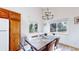 Bright dining room featuring ample natural light, a modern chandelier, and seating for six at 11348 Ranch Elsie Rd, Golden, CO 80403