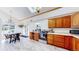 Bright eat-in kitchen with wood cabinets, stainless steel range, and skylight at 11348 Ranch Elsie Rd, Golden, CO 80403