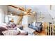 Spacious living room with hardwood floors, high ceilings, ceiling fans, and cozy furnishings at 11348 Ranch Elsie Rd, Golden, CO 80403