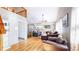 Bright living room featuring hardwood floors, comfortable seating, and mountain views at 11348 Ranch Elsie Rd, Golden, CO 80403