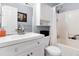 Well-lit bathroom featuring a toilet, shower and vanity sink with white cabinets at 3226 W Girard Ave # D, Englewood, CO 80110